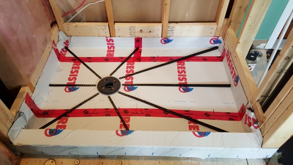 Membrane protector over the plywood subfloor, pre-slope sticks precut